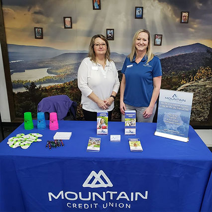 Two women tabling at event for Mountain Credit Union