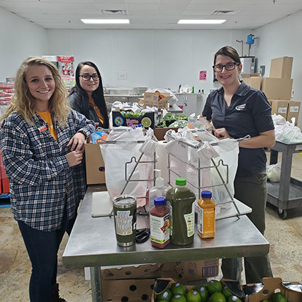 Three women volunteering in food bank
