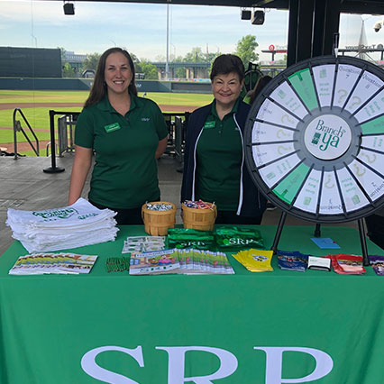 Two women tabling for SRP Credit Union at baseball field