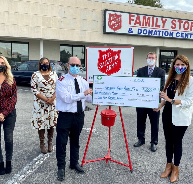 Men and women standing next to Salvation Army Family Store